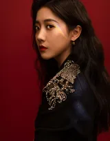 李艺彤红色背景下穿着黑色西装演出服写真图片